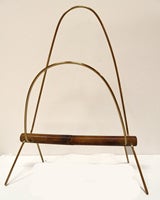 This elegant, mid-century modern magazine rack was handmade in brass and bamboo by the masterful Viennese designer Carl Auböck (1900-57). 
Auböck received four gold medals at the Triennal di Milano in 1954 amongst many other accolades.
The