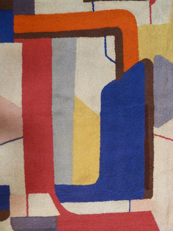 This handmade looped tapestry depicting interlocking square motifs was woven by Bert Miripolsky using a cheerful, mid-century palette .
The work is signed in the bottom right corner; the back features several loops for hanging. 
Listed American