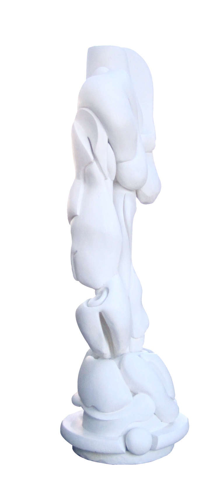 This white plaster sculpture seems to be a compilation of various figural elements merged and arranged in a contemplative, surrealist fashion. The smoothness of the material coupled with the shapes present suggests human forms in an abstract context.