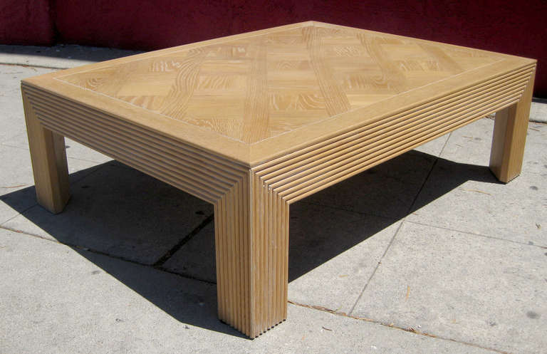 Tthis larger-scale coffee table manufactured by Lane features a ribbed wood frame topped off by a parquet surface. It's made of cerused oak.