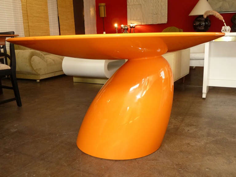 This sculptural, orange dining table by Finnish design luminary Eero Aarnio (b. 1932) was first exhibited at the International Furniture Fair in Cologne in 2003. Rendered in fiberglass the table seats six comfortably. Aarnio had this to say about