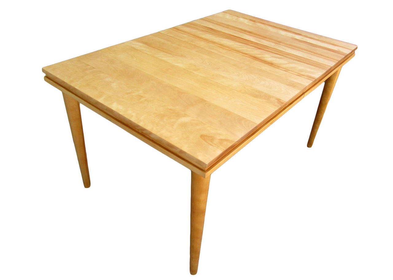 Like all his work Russel Wright made this table very simple using solid maple. The maple chosen has a beautiful grain.
This table has 2 extensions, each one adding 14 inches in width.