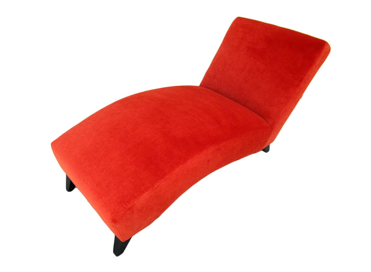 Very comfortable chaise re-upholstered in rust color velvet with black stained tapered legs.