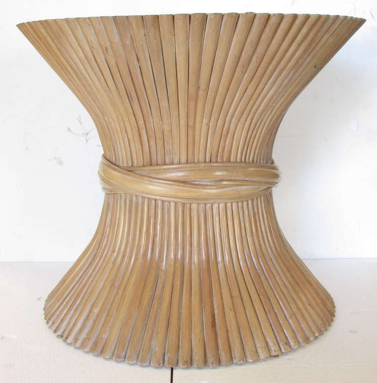 This mid-century modern side table is made of many pieces of bent and cut bamboo that fit together to form a classic sheaf of wheat shape. A custom glass top of any dimension can be made if desired.