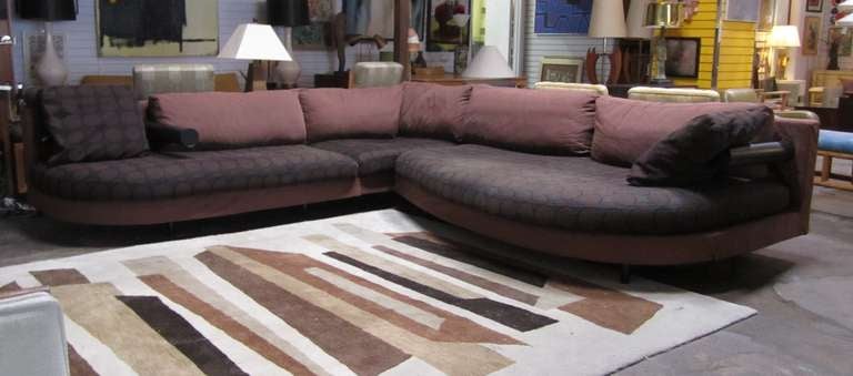In 1986, Italian designer, Antonio Citterio designed the “Sity” modular seating system for B & B Italia. This particular sectional is comprised of three pieces: an a-symmetrical, rounded sofa with a distinctive, cylindrical leather arm rest on the