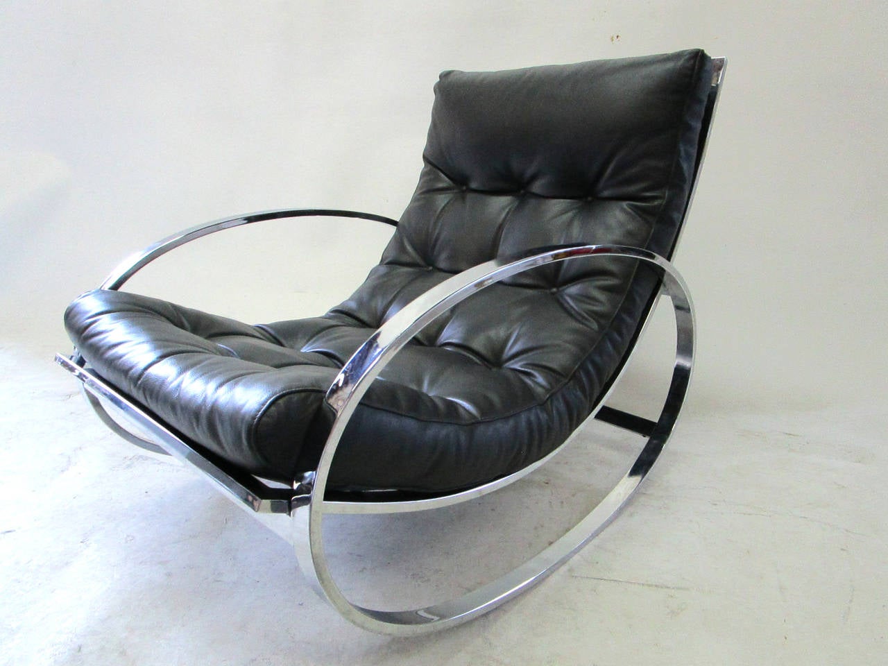 This rocking chair and stool by the well known American  designer Milo Baughman is in wonderful original condition. The leather and aluminum construction make for a stylish, modern and conformable addition to any space. ..