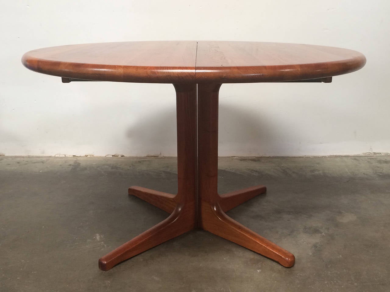 Danish designed  by Glostrup Mobel Fabric this table is made of teak. It has two leaves to expand from round dimension of 47