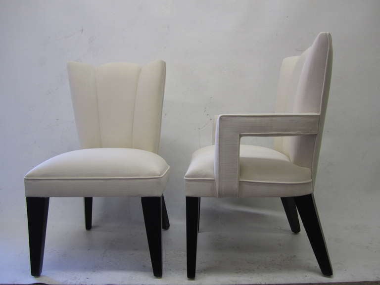 This set of Hollywood Regency dining chairs includes four side chairs and two arm chairs. The backs, seats and arms are fully upholstered in a off-white fabric which rest on tapered legs finished in black lacquer.
They are extremely comfortable!