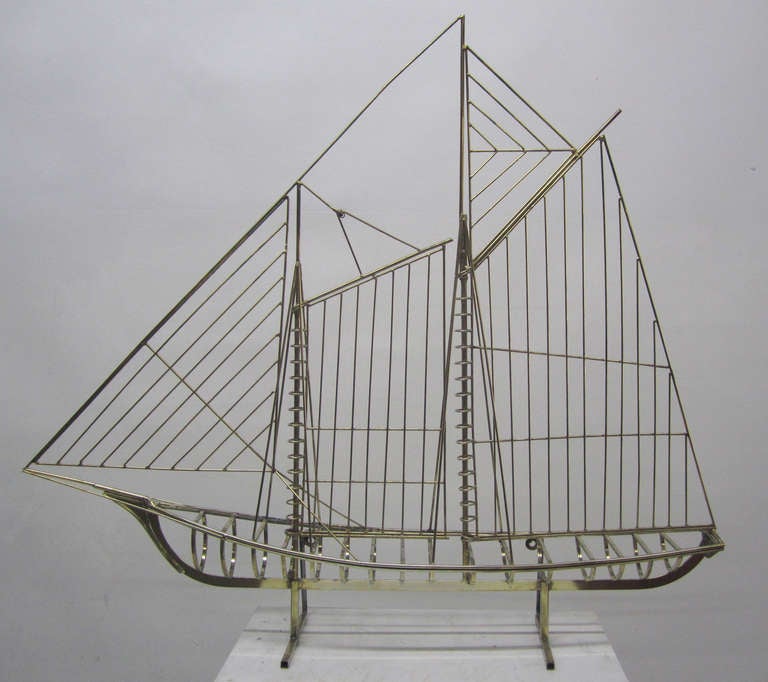This brass sculpture by Curtis Jere for Artisan House depicting the skeleton of a large sailboat has proved to be one of their most collectible mid-century modern masterpieces. The boat can stand alone or can be wall-mounted via an attachment on the