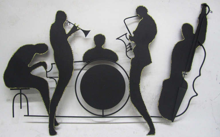 This wall-mounted sculpture by Curtis Jere depicts a five-person jazz band playing the piano, trumpet, drums, saxophone and bass. This celebrated, collectible design is one of the designers' classic pieces.