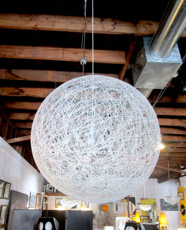 This spun fiberglass pendant features a large, open outer shell that encases a single lightbulb. There is an arm-sized hole near the top so that the bulb can be changed. Due to its size and impeccable craftsmanship, this pendant is truly