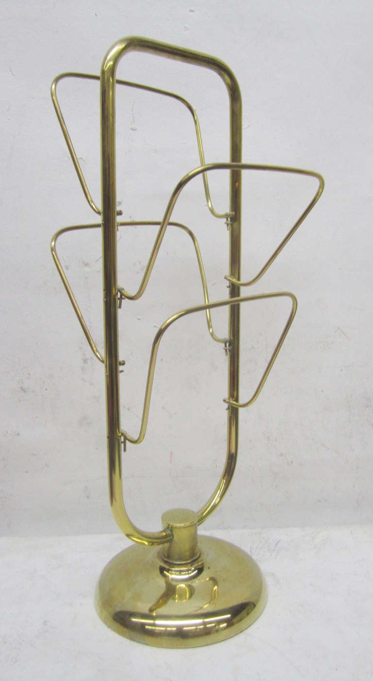 This four-tier 1950s magazine rack is made entirely of brass tubing and rests on a circular, sturdy brass base.