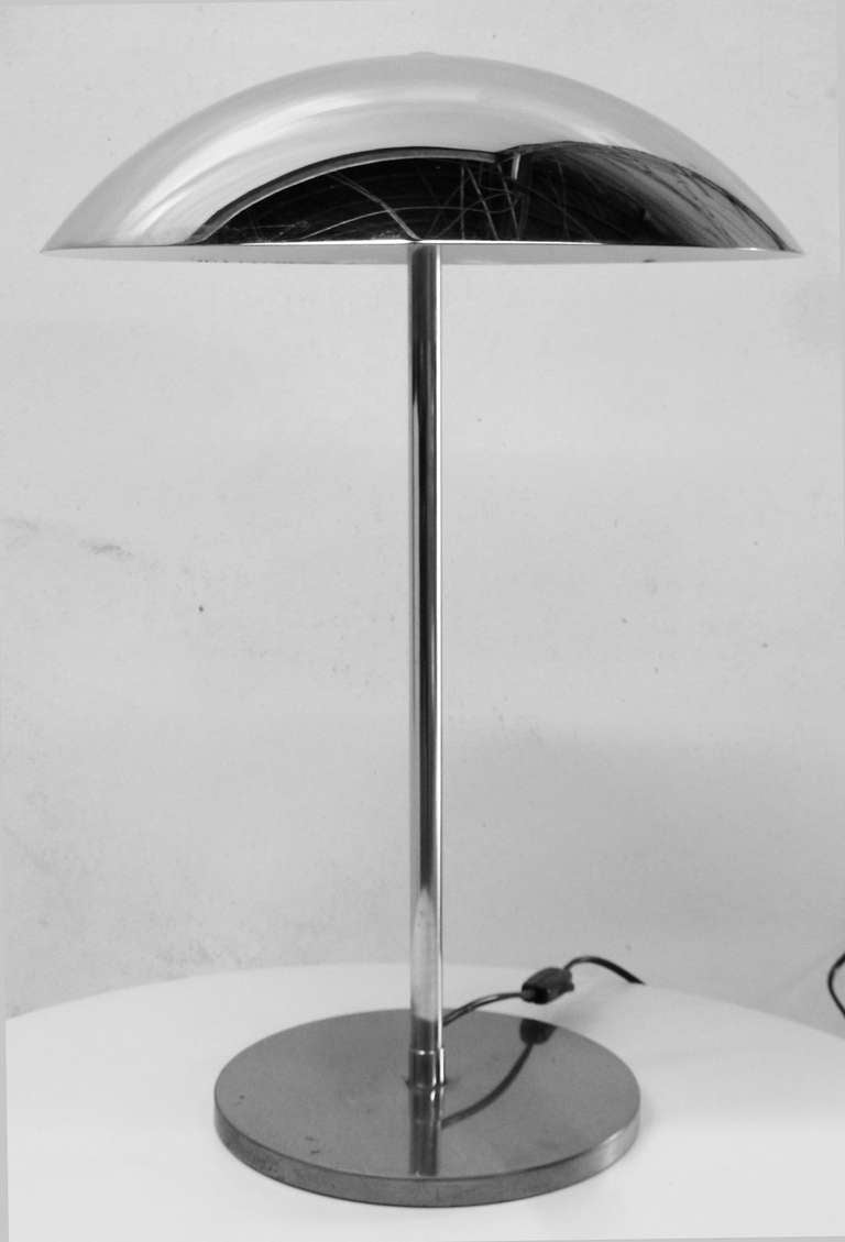 Pair of elegant chrome table lamps with slender stems and convex chrome shades by Lumess. Wired and in working condition. Each lamp uses two 40W-max bulbs. Original 