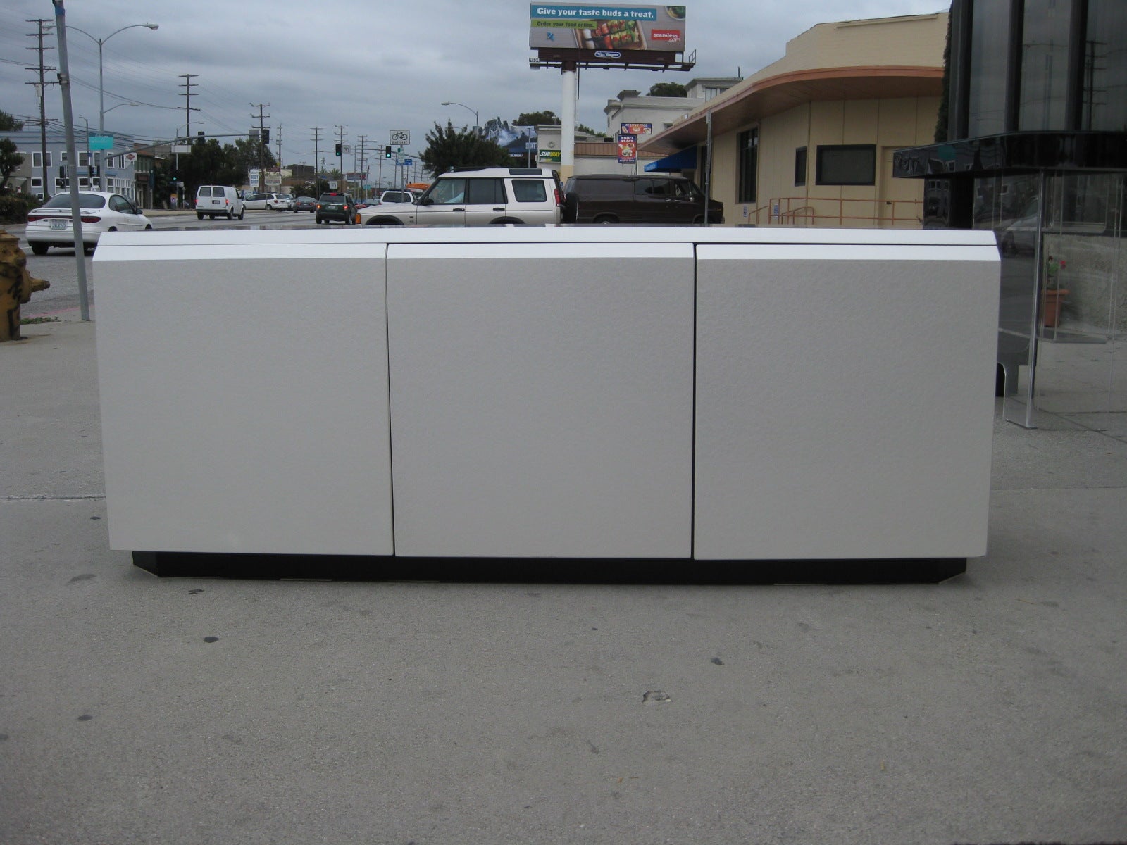 This 1970s credenza by Rougier features a unique iridescent lacquer finish in a pearl gray tone on both the top and front. The rest of the piece including the inside has a rich black lacquer finish. There are three push to open doors, the left two