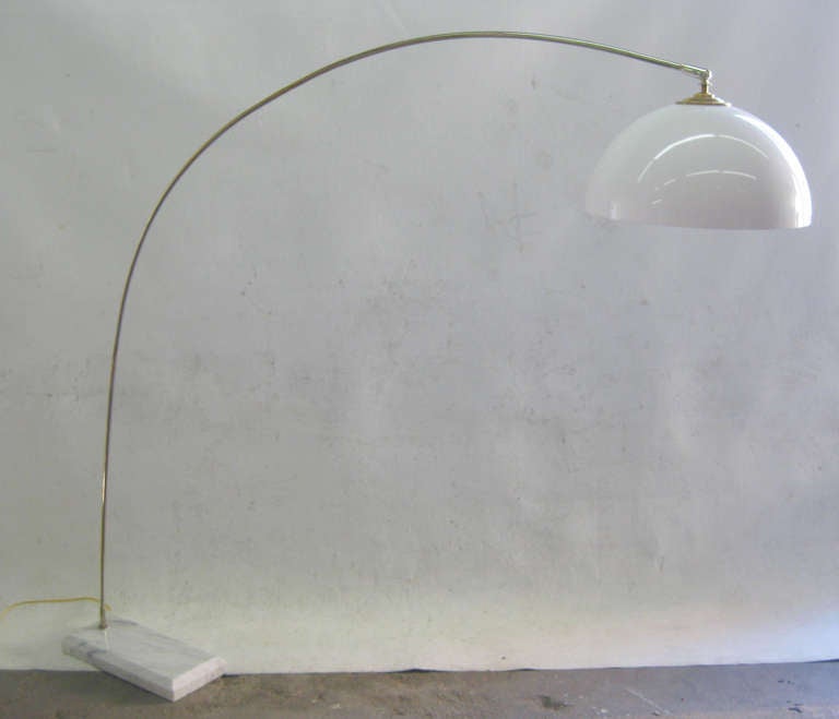 This graceful arc lamp features a white marble base which supports a long, sinuous chrome arm that finishes with a brass cap over a white acrylic shade. 
The measurements listed are for the size of the marble base and the tallest point of the lamp.