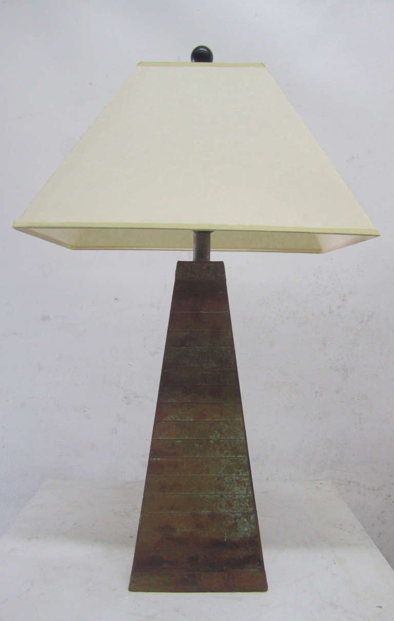 This mid-century table lamp is rendered using multiple panels of copper adhered with small nails in the same material. The four-sided lamp features a wonderful patina which includes a range of colors from green, to orange to rust and many in