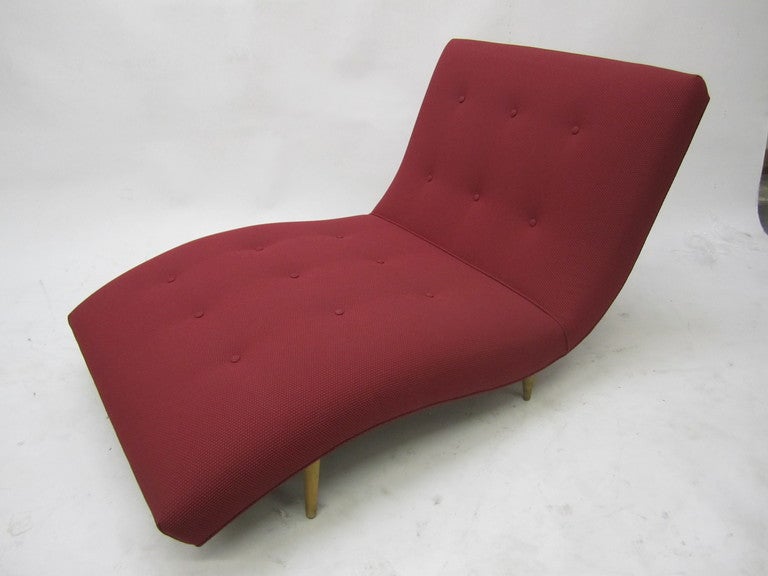 1950's low profile chaise upholstered with tapered legs. Whimsical design and perfect for a great read. In the manner of George Nelson.