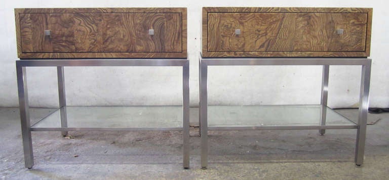 Pair of single-drawer burlwood nightstands with well-constructed, minimal chrome frames. There is a lower glass tier for added storage. Stamped 