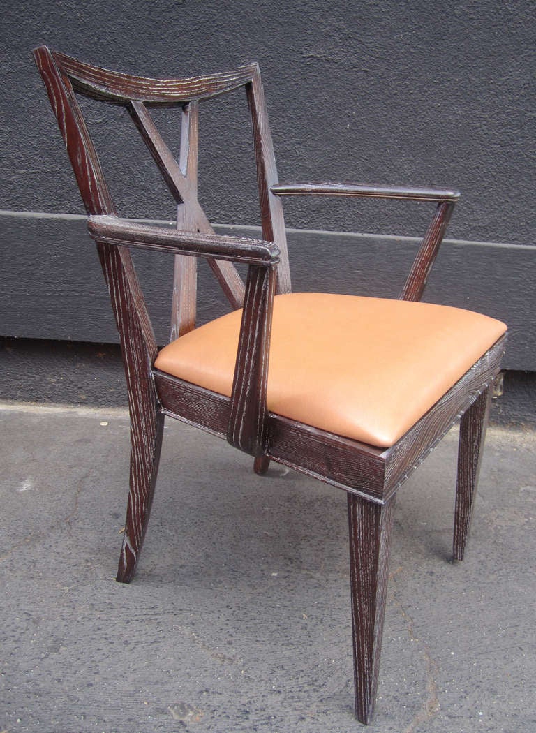 One captain's chairs and 5 side chairs by Paul Frankl newly refinished in a burnt amber stain and a cerused finish. Seats have been newly re-upholstered in cognac-toned leather.