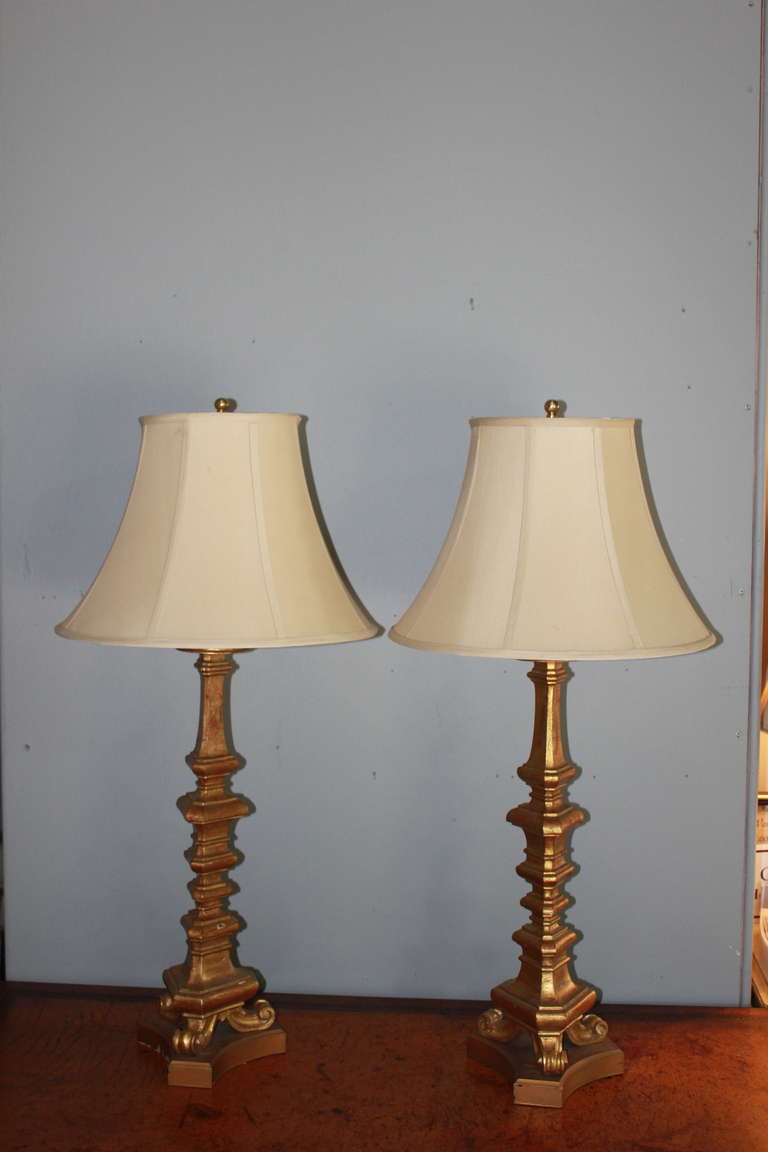 Pair of French giltwood table lamps, circa 1940s. Available with or without shades. Gilt can be touched up upon request before shipping. Beautiful soft glow to aged gilt.