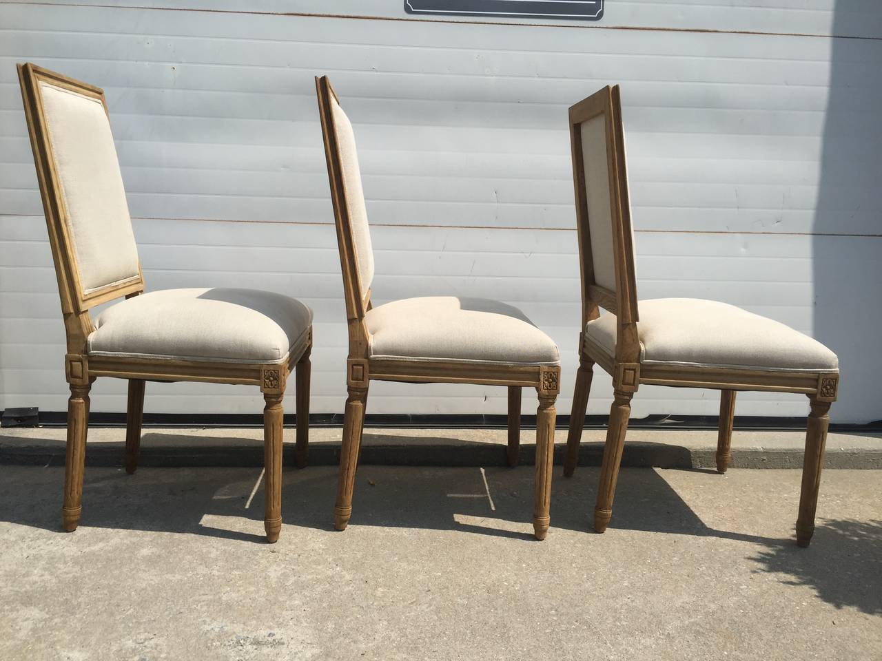 New square back French chairs in Belgian Linen.  Wood is finished with a Belgian oak finish.  Available in ANY quantity.  May need to be ordered if not in stock.  Please call showroom! We have a set of 6 at the moment