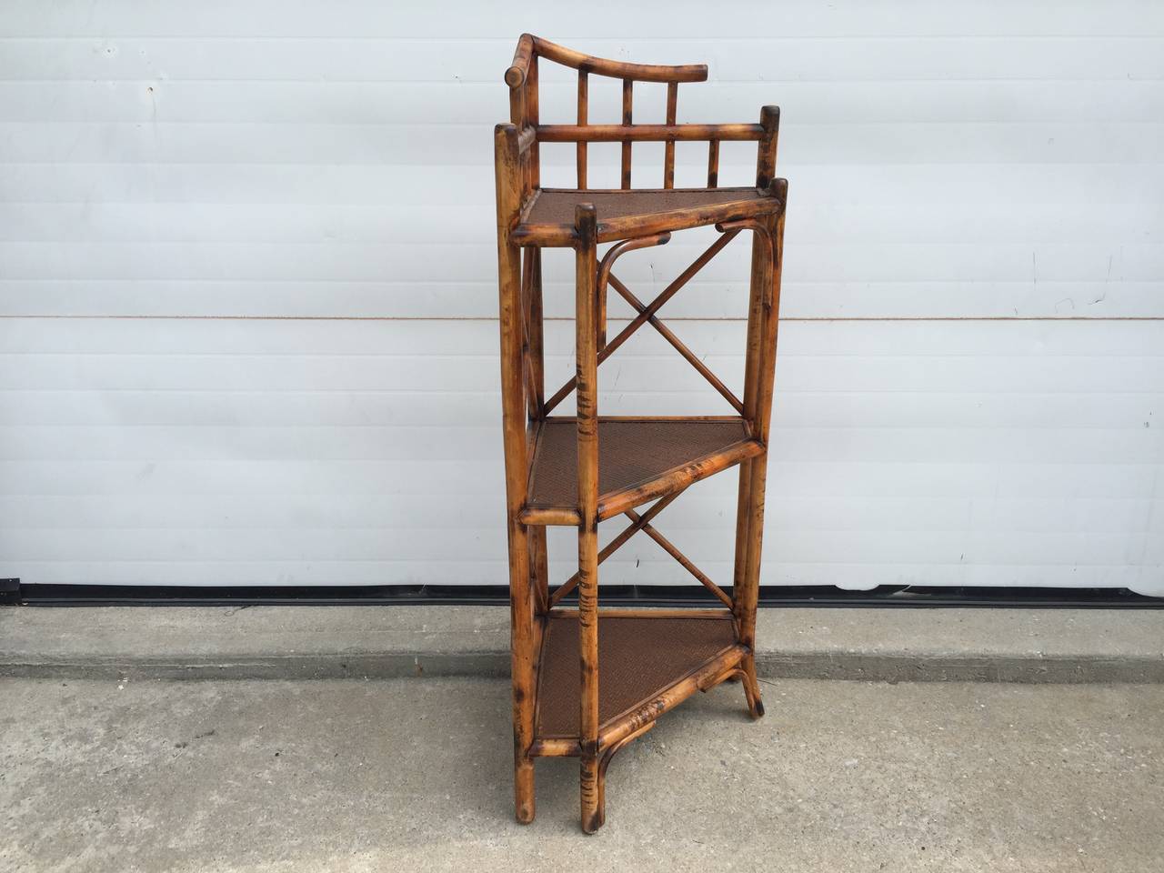 This handy corner etagere has three levels of rattan shelving to choose from.  The X cross supports make the shelves incredibly stable.  Built in 1930's England, this is a beautiful piece!
