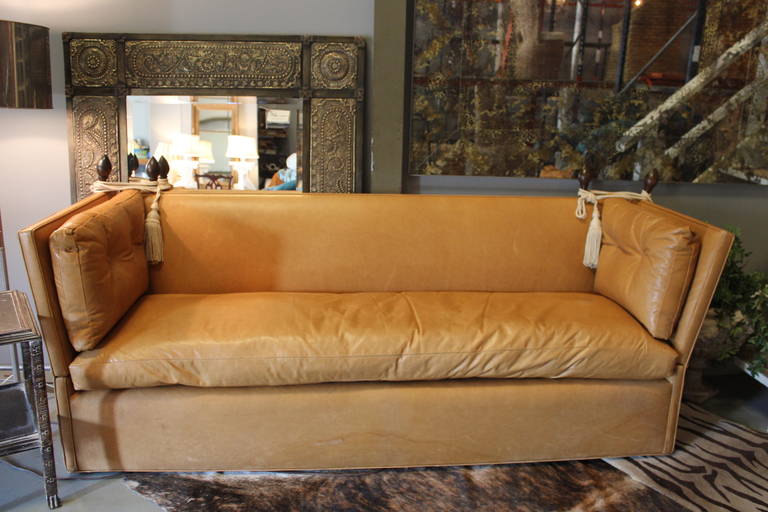 Wonderful Knole style aged cognac leather sofa, made popular again by Downtown Abbey.  The Knole sofa was common in aristocratic households and features adjustable sides which were designed to drop down so visiting royalty could stretch out for a