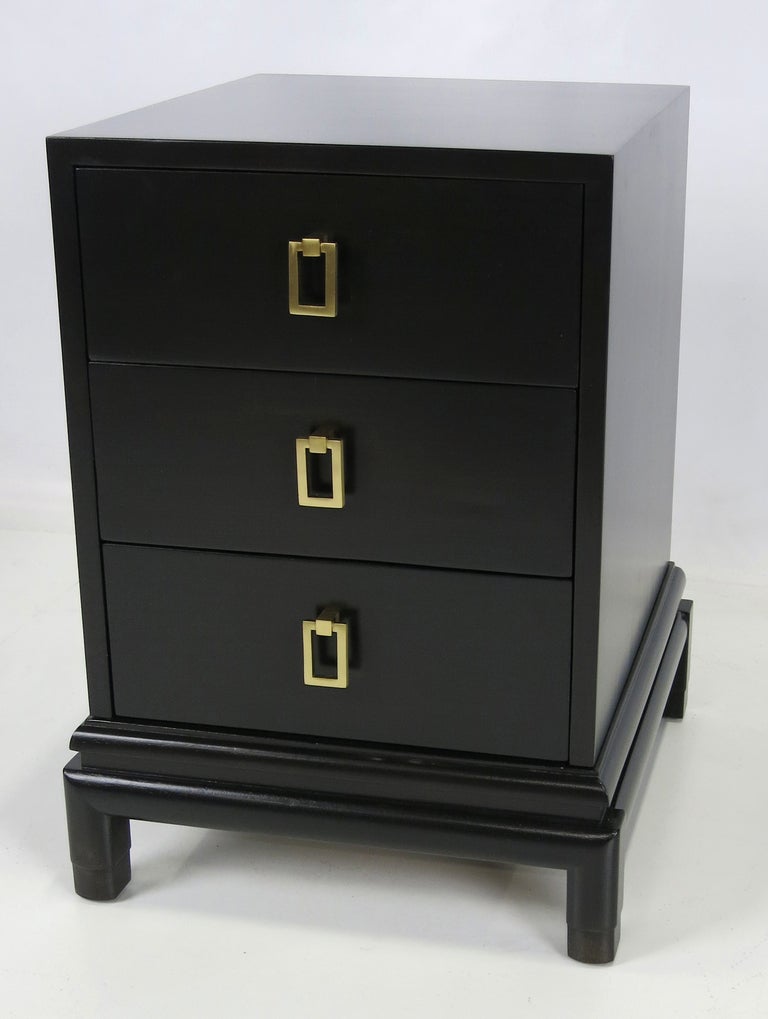Pair of Ebony lacquered Nightstands with drop ring hardware by Renzo Rutili for Johnson Furniture.  The pair have been fully restored and refinished in Ebony lacquer.