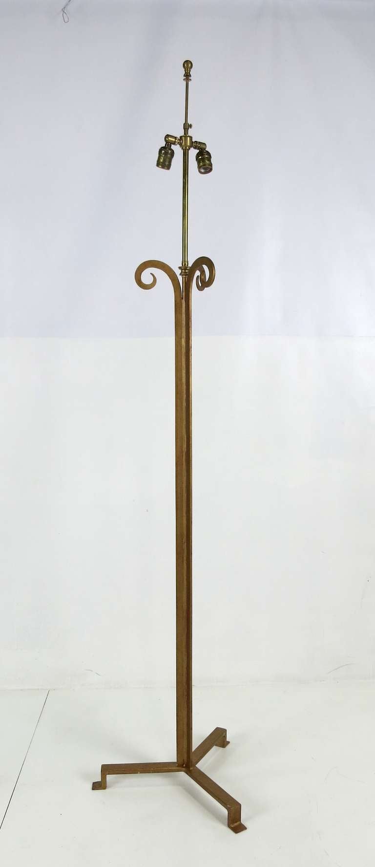 Pair of Gilt Iron Floor Lamps with Tripod Base after Maison Ramsay.