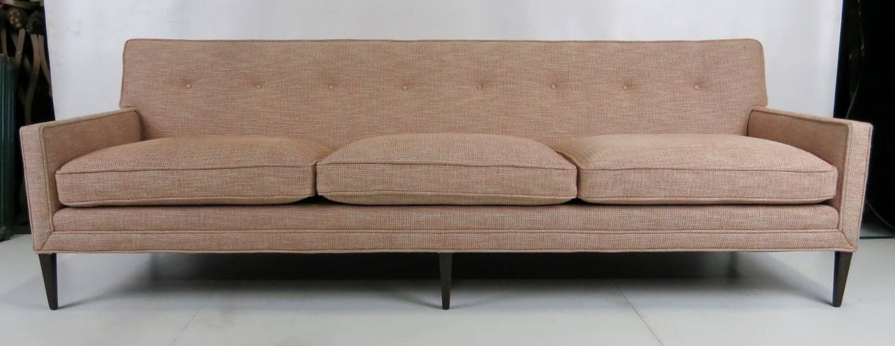 Fabulous Midcentury sofa with exposed walnut frame in the style of Paul McCobb. The high end designer piece has been meticulously restored from the frame up; refinished frames, restored foundation and cushions and freshly reupholstered in designer
