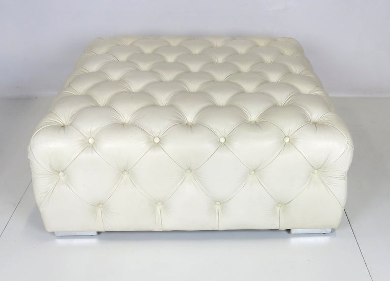 Beautiful quality tufted Leather Ottoman raised on low, square chrome feet.  