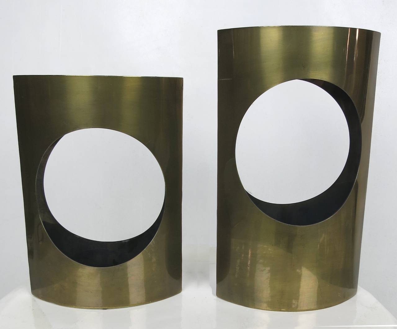 Matching pair, large and small brass ovoid vases each with a center cut open circle.

Dimension: Large vase: 12 x 3.5 x 7.
Small vase: 10 x 3 x 7.