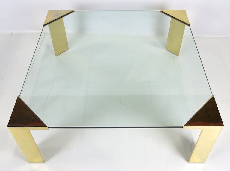 Impressive scale coffee table with brass plated steel legs. The large scale corner fixtures holds a 3/4