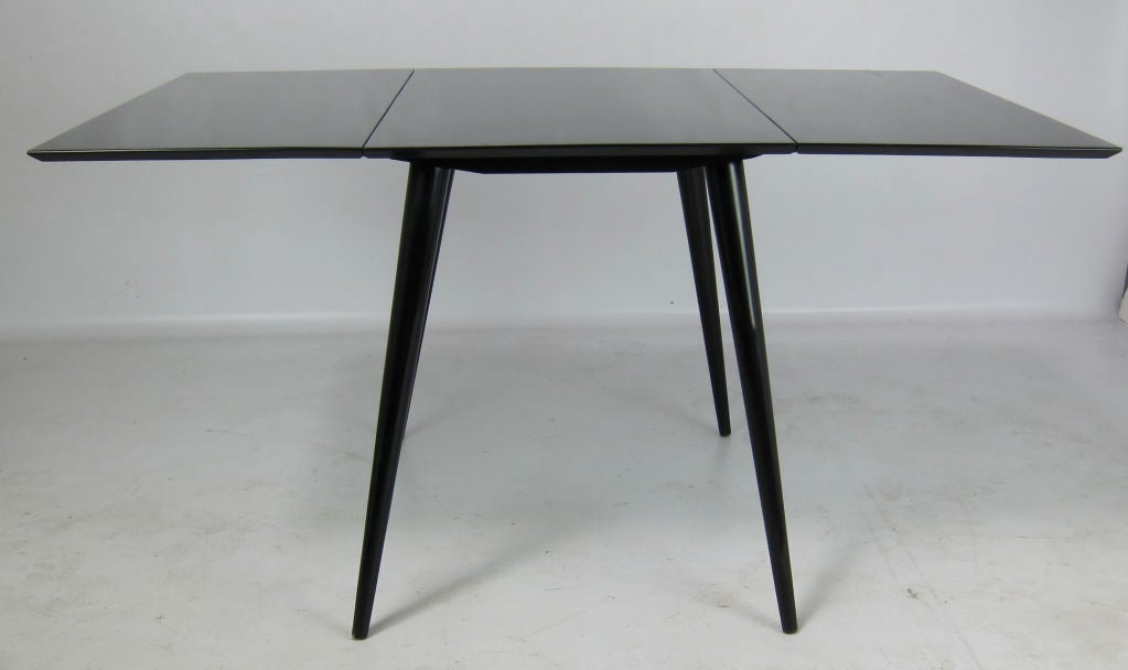 Paul McCobb Planner Group dropleaf dining table refinished in hand rubbed black lacquer.