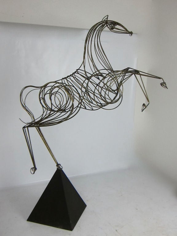 Huge brass wire sculpture of a Rampant Horse, possibly the largest Jere sculpture of all, mounted on a pyramid form base. The beautifully rendered, nearly life-sized figure swivels in its black enameled base. This Cavallino Rampante would be a great