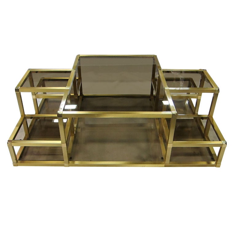 Sculptural Brass Cityscape style Coffee Table with multilevel smoked glass shelves.  The beautifully crafted frame consists of heavy 1