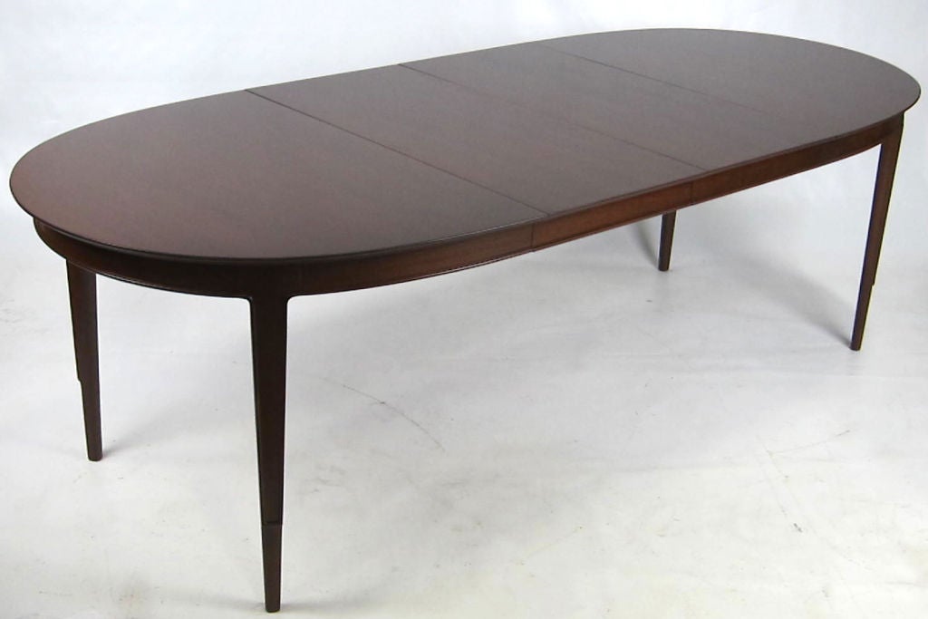 Walnut Janus Collection dining table with sculptural, carved legs by John Stuart-NY.  Two 18