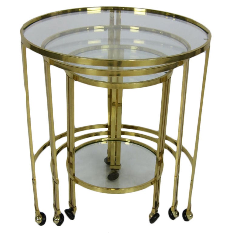 Italian brass nesting tables with rubber tread casters.  Beautiful materials and construction.  Largest table is 20