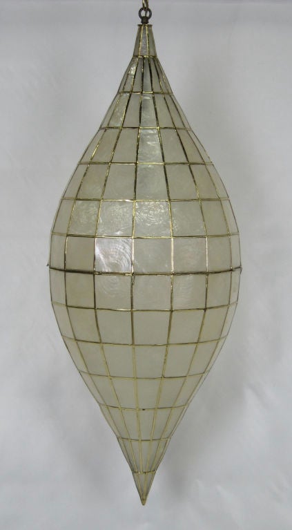Very large Oblique Spheroid form Capiz Shell pendant light fixture with bright gold plated brass frame.