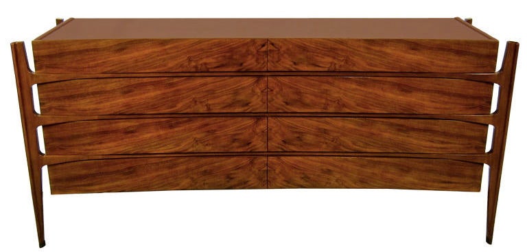 Rare rosewood version of this coveted eight-drawer dresser with matched grain curved drawer-fronts and sculpted exterior mounted legs with leather sabots. This finely crafted piece is distinguished by the most beautiful matched veneer ever seen on