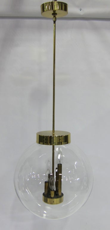 Large scale and fine quality clear glass globe Chandelier or pendant lamp with brass mounts by Robert Long Lighting.