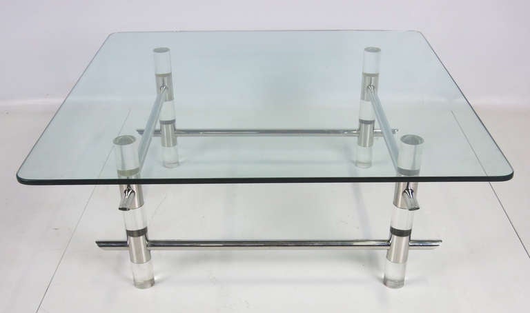 Beautiful Lucite and chrome cocktail table by Les Prismatique. The base is comprised of 3