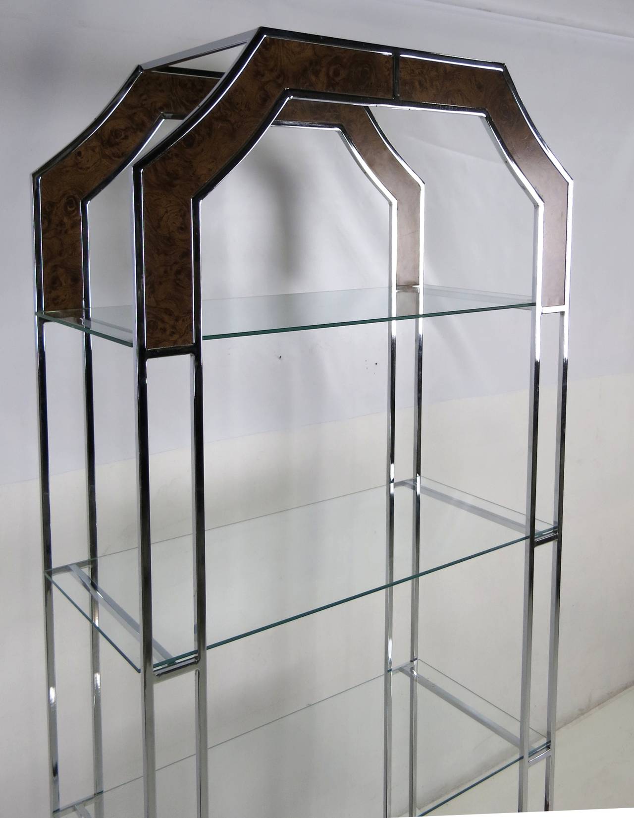Trellis style chrome étagerés with inset burl veneer trim in the style of Milo Baughman. Three glass shelves.