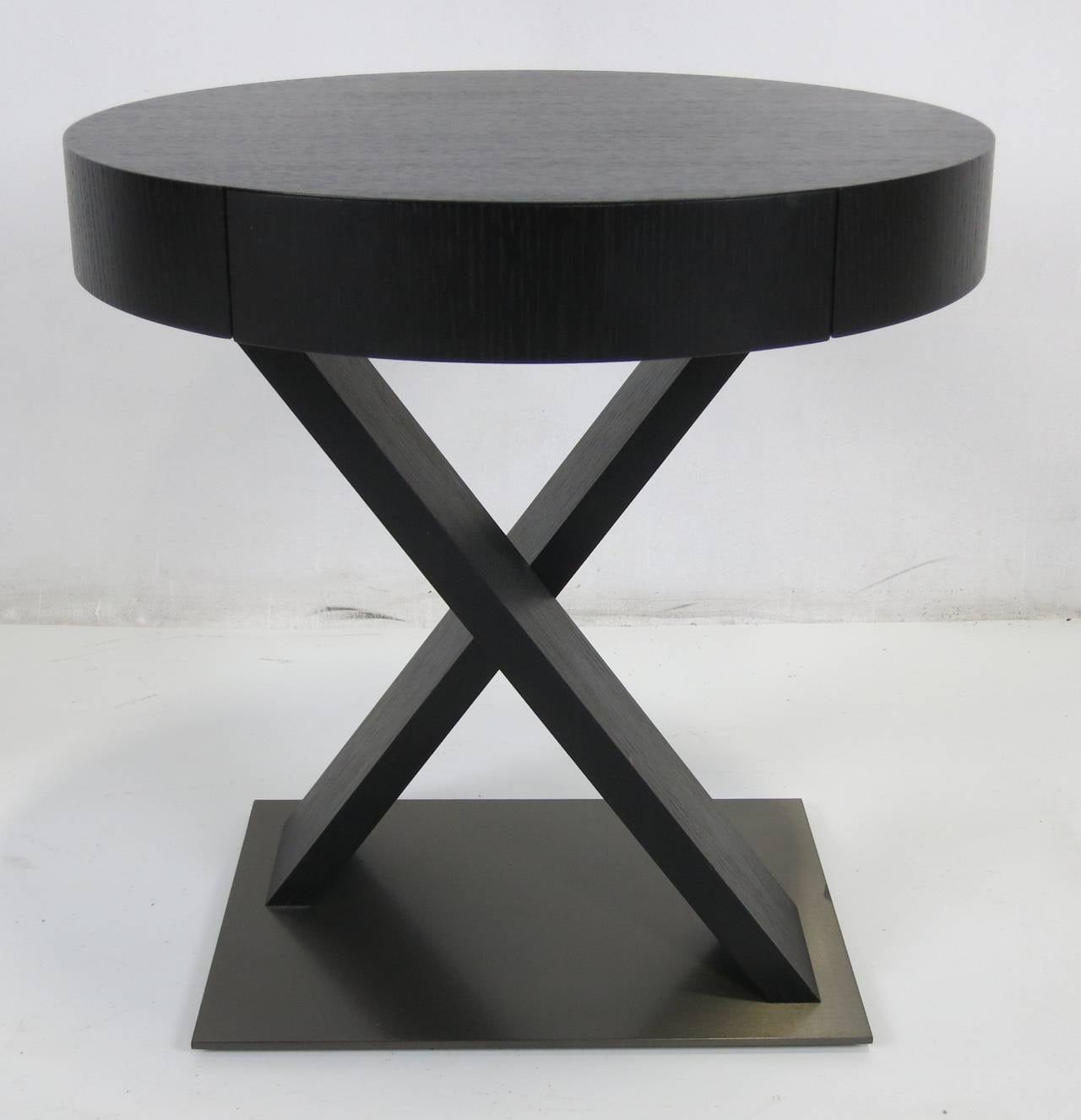 Fabulous pair of Cimarosa side tables in ebonized oak with crossed supports on a bronze base by Armani Casa. Each table has a small drawer concealed in the apron. The last photo shows the tables in Armani's bedroom in his Swiss Alps retreat.  He has