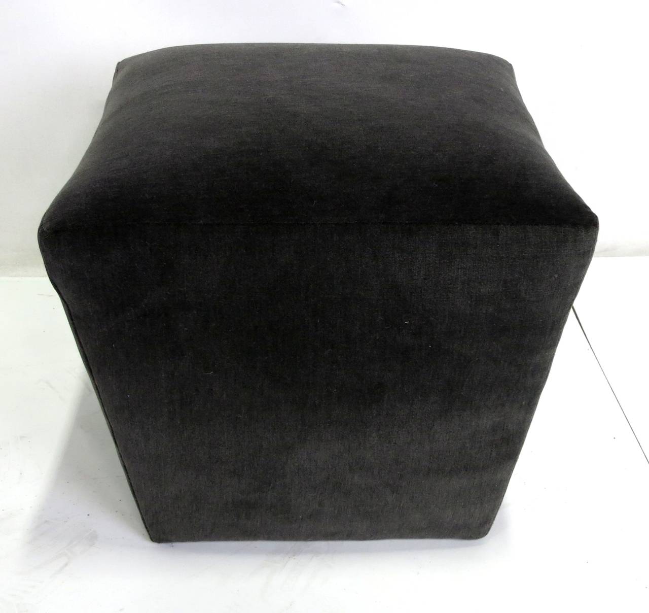 Pair of reverse tapering square poufs freshly upholstered in luxurious charcoal grey velvet.