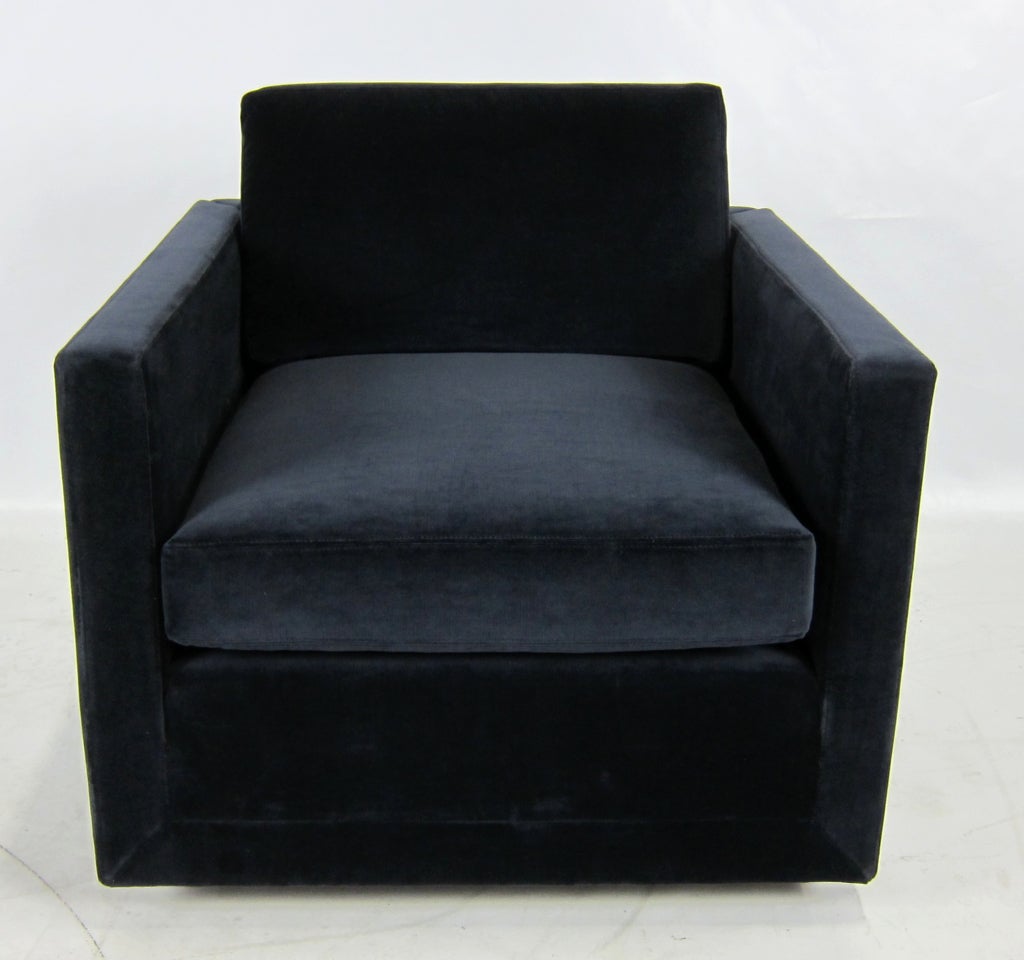 Fine pair of Lounge Chairs on recessed black plinth style bases, which give the chairs the illusion of floating.  The pair have been reupholstered in luxurious Navy Blue Velvet.  Overall height, including the back cushion is 30