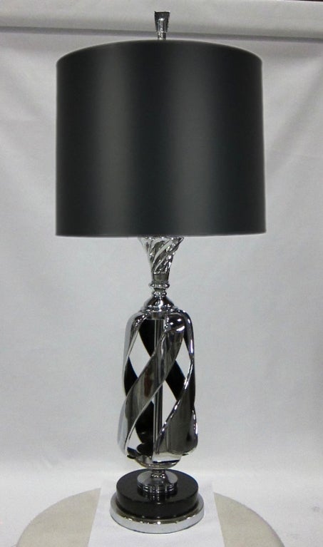 Pair of solid Nickel plated steel Spiral cage form lamps on black enamel mounted base.  The lamps, including new Nickel plated brass sockets and mountings have been replated and restored to as-new condition.