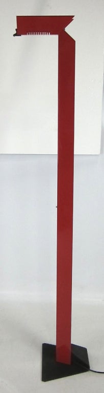 Red floor lamp on black wrinkle base with tilting light head.  Dimmable halogen light source with slide dimmer on column.  Please browse our entire inventory at www.antiquesdumonde.1stdibs.com