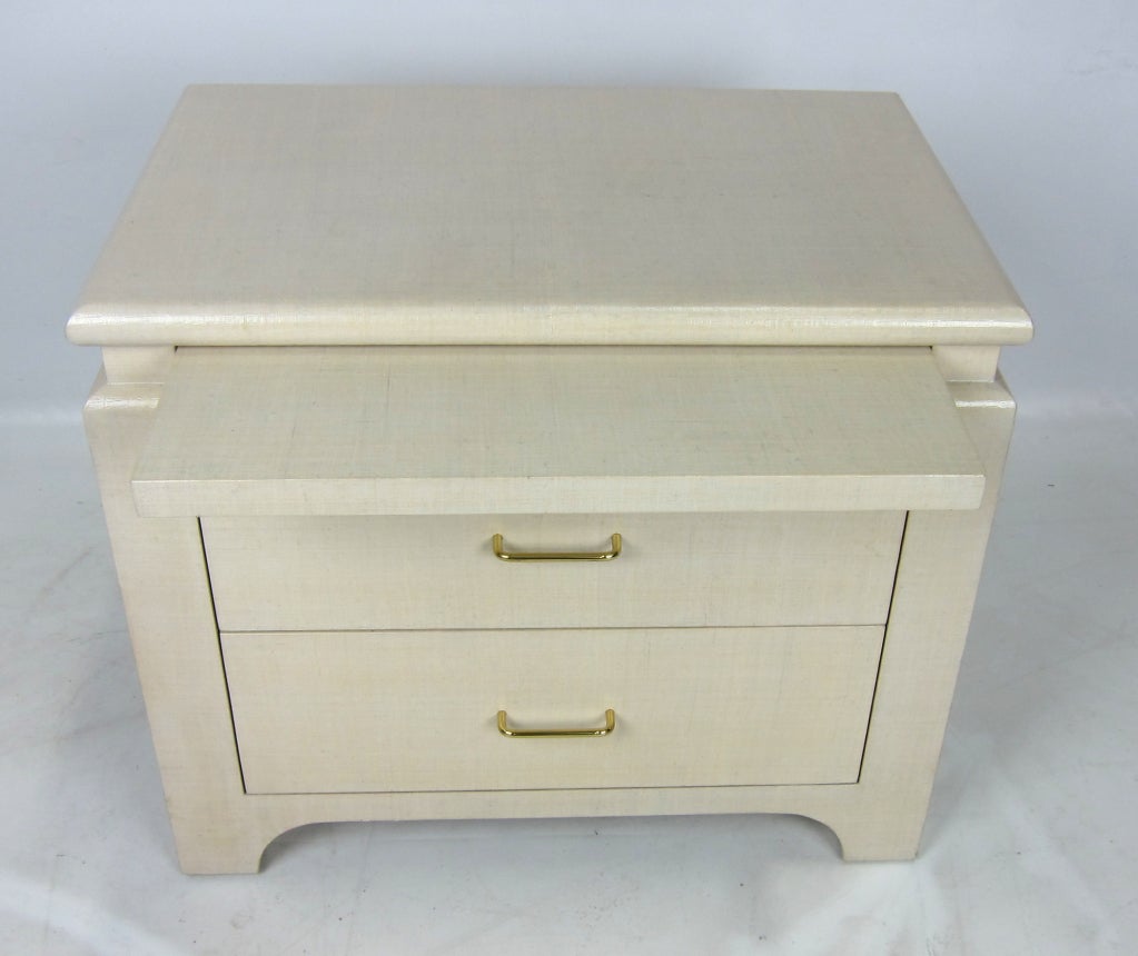 Elegant Grasscloth clad nightstand with concealed shelf and polished brass pulls.  