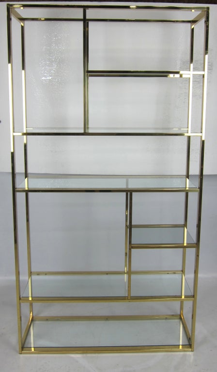 Pair of Brass Etageres with Glass Shelves.  Please browse our entire inventory at www.antiquesdumonde.1stdibs.com